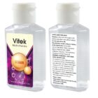 Two bottles of Vitek Multi-Vitamins hand sanitizer, front and back view. Front label shows product name and design; back label includes directions, ingredients, and a flammability warning. Bottles contain 60ml and have flip-top caps.