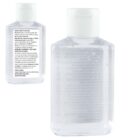 Two clear plastic bottles, each containing hand sanitizer. The larger bottle has visible bubbles within the liquid and a label with text. The smaller bottle is placed slightly behind, featuring a similar design and textual label.