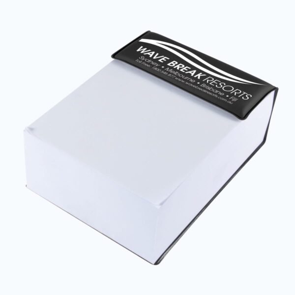 A rectangular notepad with a black top edge displaying Wave Break Resorts in white text, accompanied by contact information. The rest of the notepad is white, and it appears to be resting on a light surface.