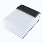 A small rectangular box with a white bottom and a black lid, resembling a closed book. The lid has a slight overhang, giving a minimalist and modern appearance against a plain white background.