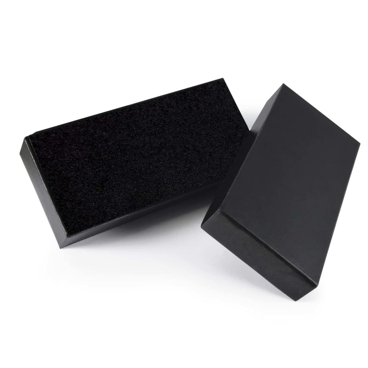 Two rectangular black boxes, one standing upright and the other lying flat. The boxes have a sleek, minimalist design, with smooth surfaces and sharp edges.