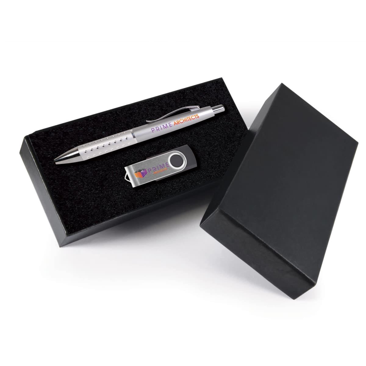 A black gift box with a pen and a USB flash drive. The pen is silver with blue and red text, while the USB drive is gray with similar colored text. The box is partially open, showing the contents inside.