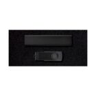 A black rectangular device and a black USB drive with a circular button are set against a dark background.