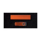 Orange rectangular object and a matching orange USB flash drive on a black surface.