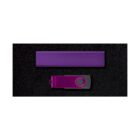A purple USB flash drive with a swivel cover lies horizontally on a black surface. Above it, a matching purple rectangular box is positioned parallel to the drive.