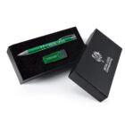A black gift box with silver text containing a green pen and a green USB flash drive, both branded with Regal Legal. The box is partially open, resting on a white background.