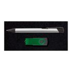 A silver pen with a black cap is placed above a green USB flash drive on a black textured background.