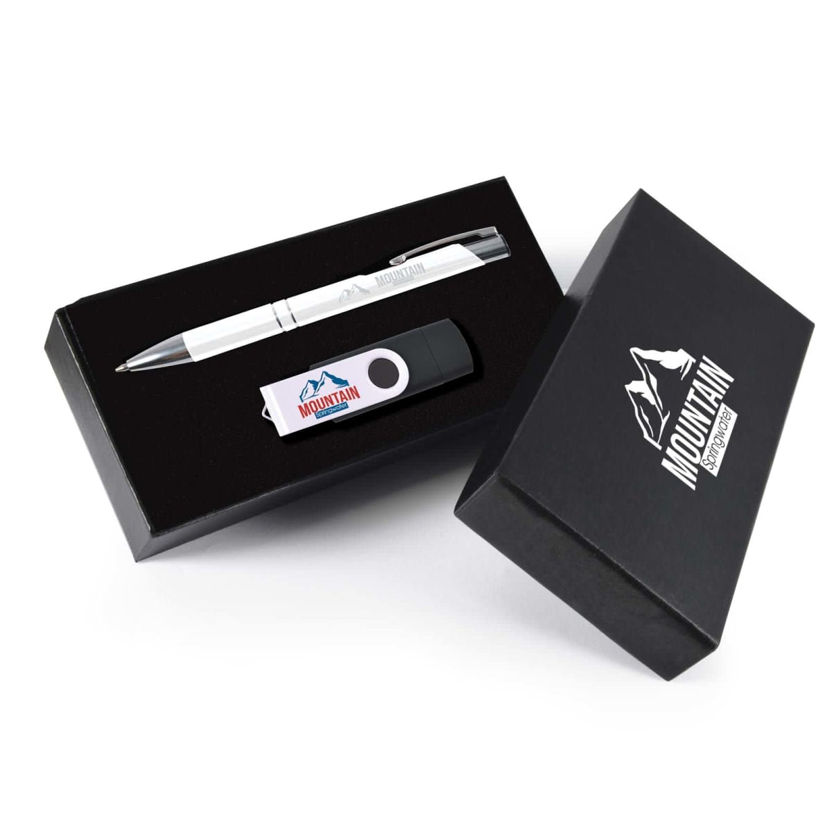 Black gift box containing a silver pen and a USB drive with a black and white design, both featuring a mountain logo. The box lid, placed beside the box, also displays the mountain logo and the word Mountain.