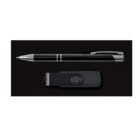 A sleek black and silver pen is placed beside a black USB flash drive against a plain black background.
