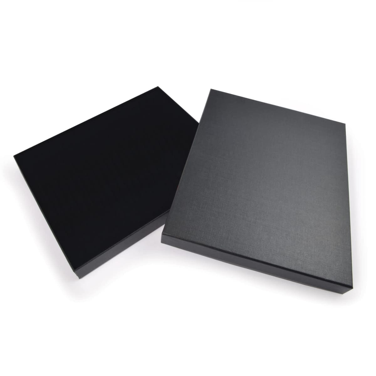 Two black rectangular boxes on a white background, one partially open showing its lid and the other closed. The boxes have a sleek, smooth surface, suggesting a modern and minimalistic design.