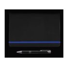 A black notebook with a blue elastic band lies closed on a black background. Below it is a black pen with silver accents.