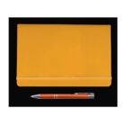 A closed yellow notebook with an elastic band, placed on a black surface. Below the notebook, there is an orange and silver pen.