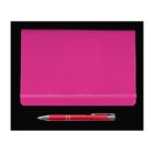 A pink notebook with a horizontal elastic band lies on a black surface. Below it, a red pen with a silver clip and tip is placed horizontally. The notebook and pen are aligned parallel to each other.
