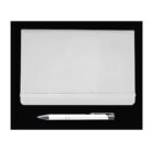 A closed silver laptop lies on a black background with a silver pen placed horizontally below it.