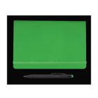 A green notebook with an elastic band is placed on a black background. Below it lies a black pen with a green tip.