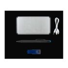 A collection of office items on a black background. Includes a silver power bank, a white USB cable with multiple connectors, a black pen with a blue tip, and a blue USB flash drive with a swivel cover.