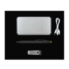 A silver rectangular power bank, a USB cable with multiple connectors, a black stylus pen, and a metallic USB flash drive are arranged on a black background.