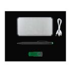 A silver rectangular power bank, a black pen with a green tip, a green and black USB flash drive, and a white charging cable with three connectors are arranged on a black background.