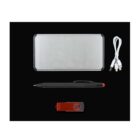 A silver portable power bank, a black pen with a red tip, a red and black USB flash drive, and a white USB charging cable with multiple connectors are arranged on a black background.