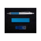 A blue and silver pen, a rectangular blue power bank, and a blue USB flash drive are arranged on a black background. The pen has a silver clip and studded grip; the USB drive has a circular latch.