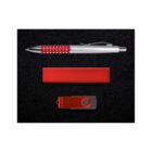 A flat lay image of a black background featuring a red and silver pen at the top, a red rectangular box in the center, and a red USB flash drive at the bottom.