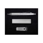 A silver ballpoint pen with a textured grip and a metallic USB flash drive are arranged side by side on a black surface. The flash drive is extended from its silver casing.