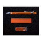 A sleek, orange pen, a rectangular orange block, and an orange USB flash drive with a swivel cover are displayed on a textured black background.