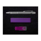 A silver pen, a rectangular purple block, and a purple USB flash drive are placed against a black background. The pen features a clip, and the USB drive has a swivel cover.