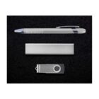 A silver pen, a rectangular metal power bank, and a silver USB flash drive with a swivel cover, all arranged on a black background.