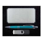A sleek, silver metal card holder, a teal pen with silver accents, and a silver and black USB flash drive are displayed on a black surface.