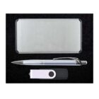 A silver rectangular power bank, a silver and black pen, and a black and white USB flash drive are arranged neatly on a black background.