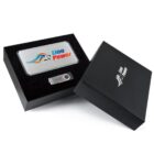 Black gift box with Lion Power logo contains a metal power bank and a USB drive. The items rest in black foam. The lid of the box is open and also displays the Lion Power logo.