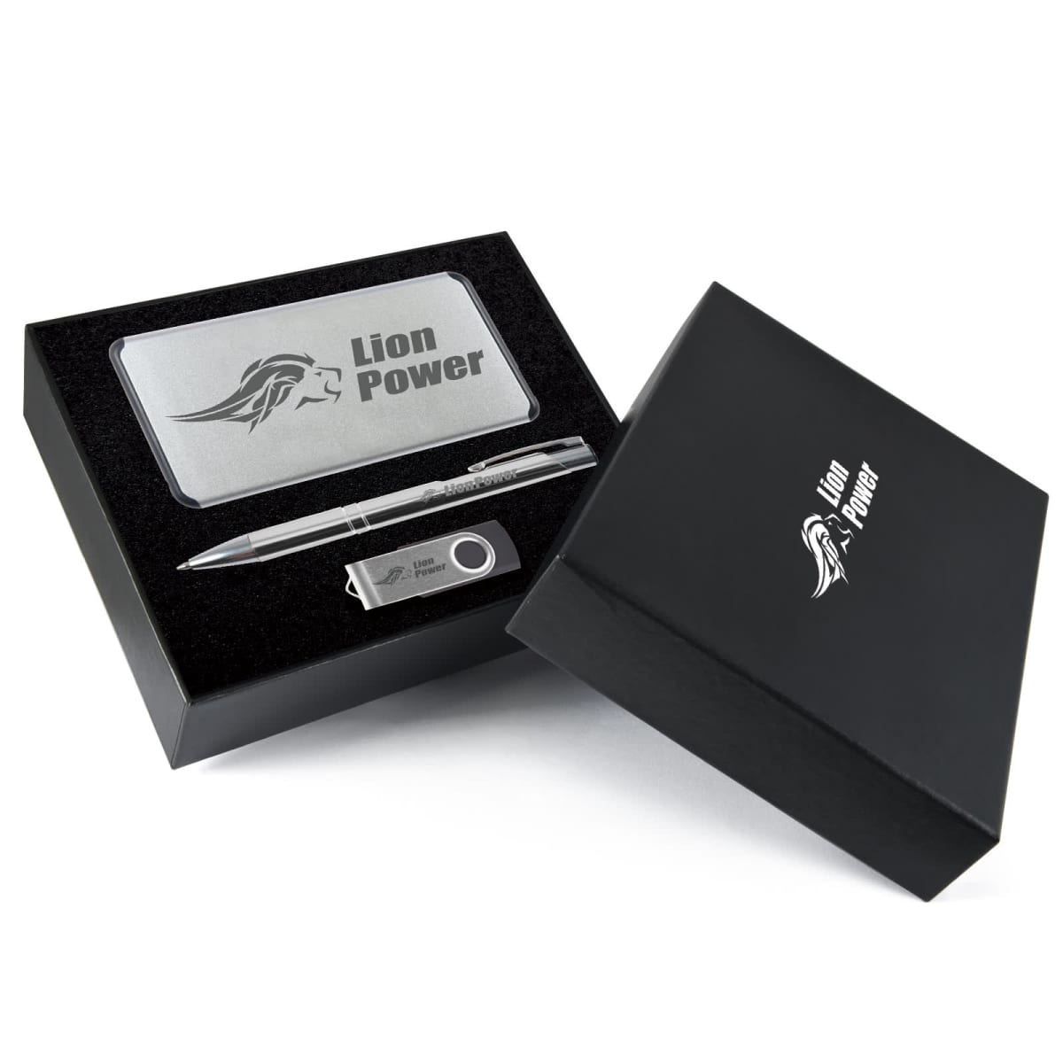 A black gift box containing a silver power bank, a pen, and a USB drive, each branded with the Lion Power logo and a lion emblem. The lid of the box is propped open, displaying the contents inside.