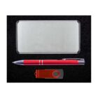 A silver rectangular power bank, a red and silver ballpoint pen, and a red USB flash drive with a swivel cover, all placed against a black background.