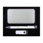 A silver rectangular metal case, a white pen with silver accents, and a white USB drive with a black circular design are placed on a black background.