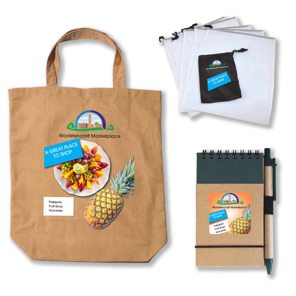 A beige tote bag with Woolstoncraft Marketplace logo and a pineapple image, a set of cloth bags, a notebook, and a pen. All items feature the same marketplace branding and colorful pineapple design.