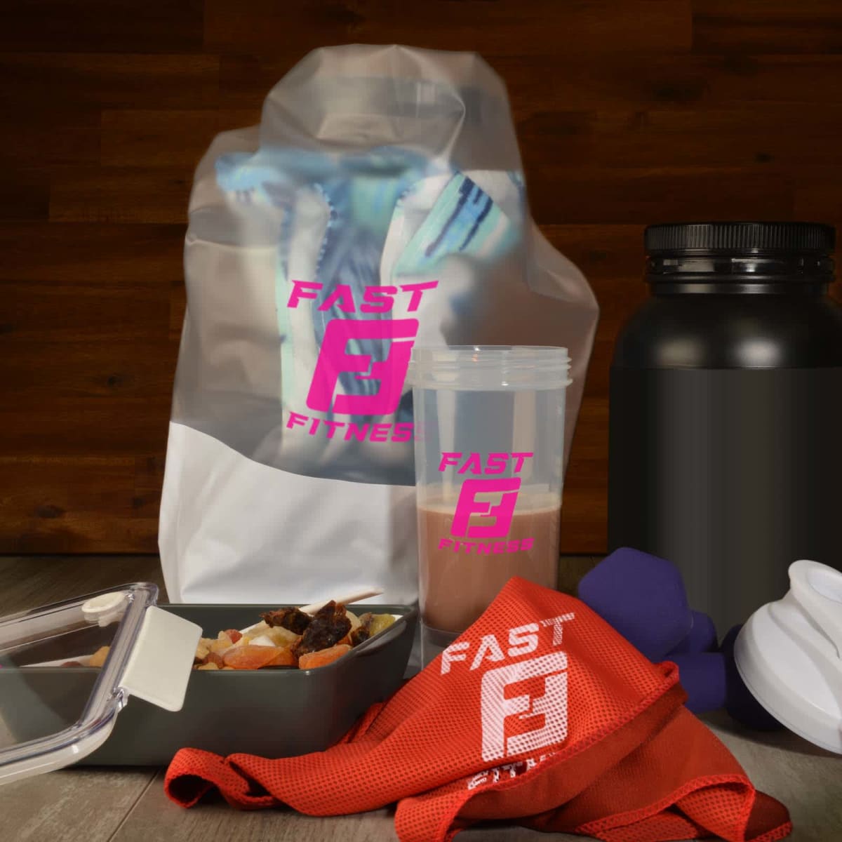 A collection of fitness items, including a protein shaker, a large powder container, a red towel labeled Fast Fitness, a meal prep container with food, a pair of purple dumbbells, and a white funnel, all set against a wooden background.