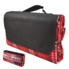 Folded red plaid picnic blanket with a black carrying handle and flap cover. A smaller rolled-up version of the blanket is shown in the bottom left corner.