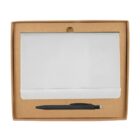 A closed white notebook with an elastic band is placed inside a brown cardboard box. Below the notebook, a black pen with a clip lies horizontally.