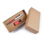 A cardboard gift box containing a red and silver pen with a polka dot design and a red USB flash drive. The lid of the box is placed slightly ajar to the right, showing its contents against a plain white background.