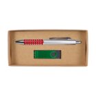 A cardboard box containing a metal pen with a red grip and silver accents, and a green USB flash drive. The pen has a click mechanism, and the USB drive features a swivel cover.