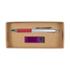 A pen with a red grip and a silver clip, and a purple USB flash drive are placed inside a brown cardboard box.