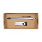 A silver pen with a textured grip and a USB drive rest inside a brown cardboard box. The box has a rectangular cutout for viewing the items.