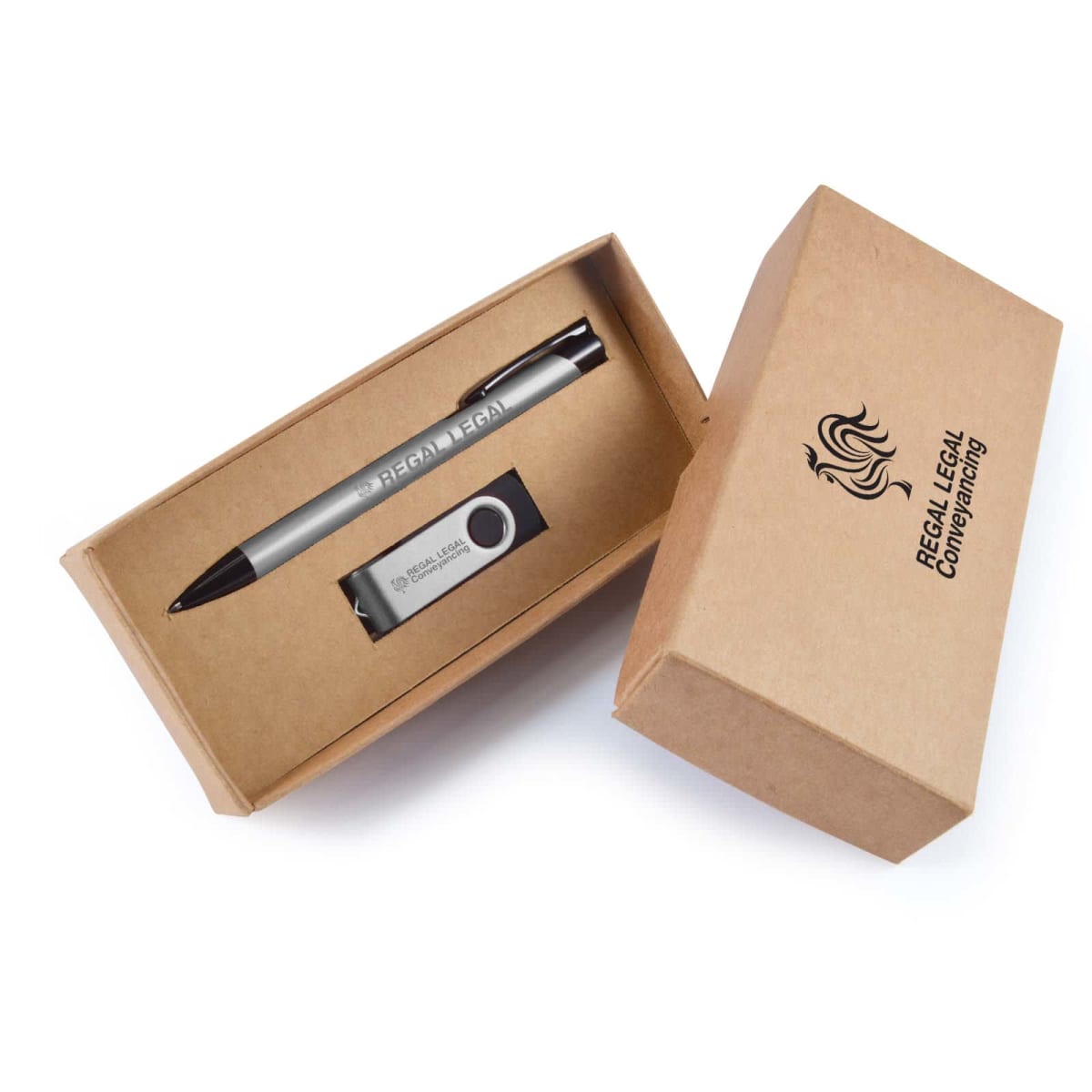 Open cardboard box containing a silver pen and a USB flash drive. The pen has text that appears faint in the image. The box lid is beside it, labeled REGAL LEGAL Conveyancing with a stylized logo of a lions head.