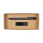 A cardboard box containing a black pen and a black USB drive. The pen is positioned horizontally at the top of the box, while the USB drive is placed below it in the center. The interior is a blank brown cardboard.