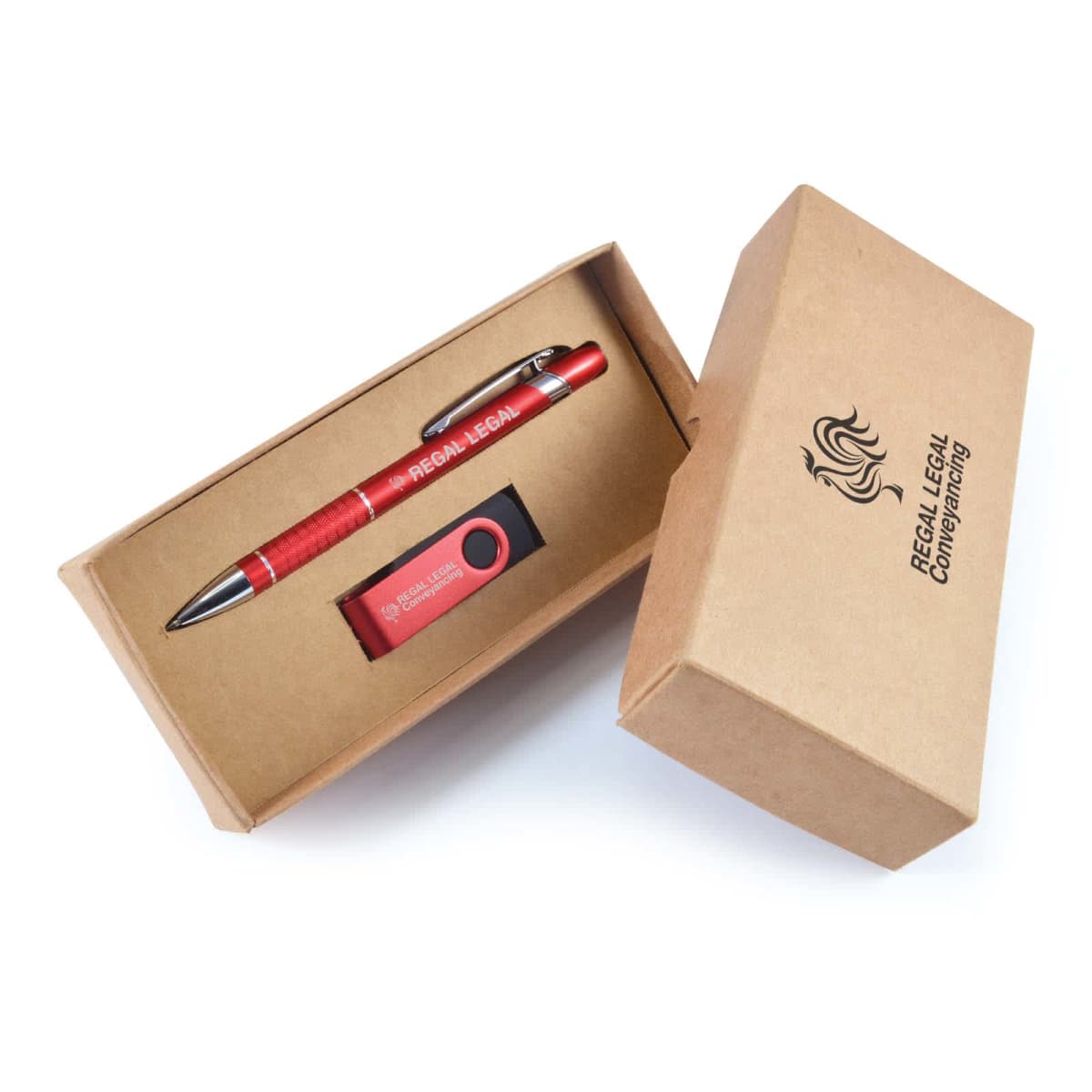 A cardboard box labeled Regal Legal Company is open, revealing a red pen and a USB flash drive inside. The pen has Regal Legal printed on it. Both items are neatly placed in custom-cut compartments within the box.