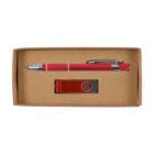 A red pen with silver accents and a matching red USB flash drive are neatly placed inside a brown cardboard box.