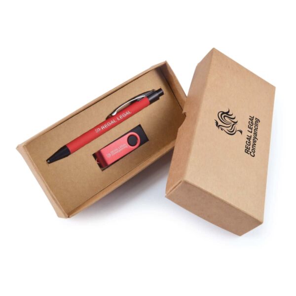 An open cardboard box displays a red pen and a USB drive with REGAL LEGAL printed on them. The box has the REGAL LEGAL CONVEYANCING logo on the top. The pen and USB are neatly placed inside.