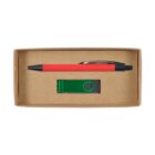 A cardboard box containing a red and black pen and a green USB drive. The pen is placed on top, and the USB drive is below it, lying horizontally. The box is open and displayed from above.