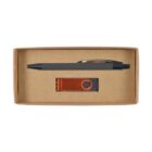 A cardboard gift box containing a black pen and an orange USB flash drive with a rotating cover. The pen and USB drive are displayed next to each other inside the box.